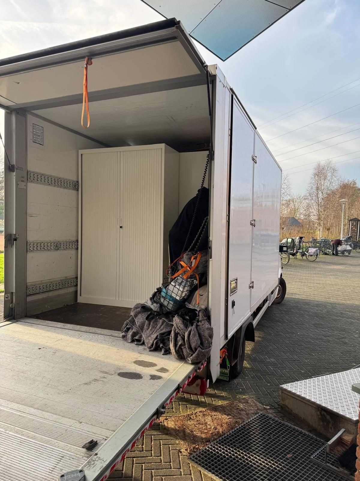A cabinet safely strapped down inside the loading space