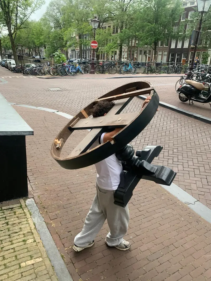 Carrying a round table along the street.